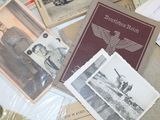 a pile of old photos and postcards on a table