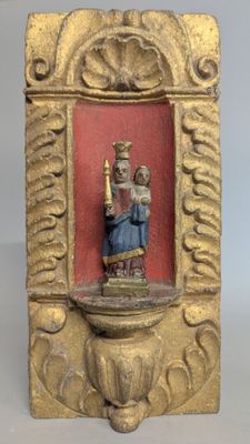 an image of a statue of a woman holding a candle in a gold frame