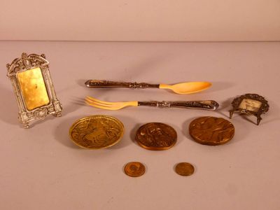 a silver spoon, fork, spoon and spoon rest on a table
