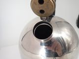 a silver vase with a hole in the middle of it