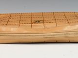 beige leather purse with zippers on a white background