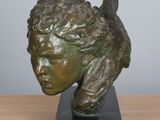 sculpture of a head of a man with a bird on it ' s head
