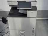 a printer sitting on top of a desk next to a computer