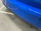a blue car parked in a parking lot