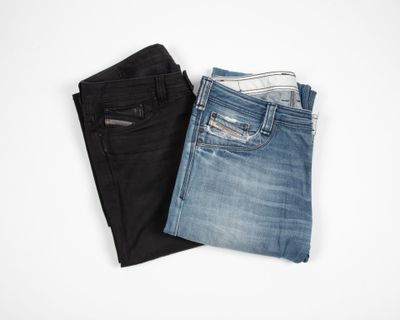 two pairs of men ' s jeans on a white background