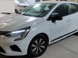 a white car parked in a garage with other cars in the background