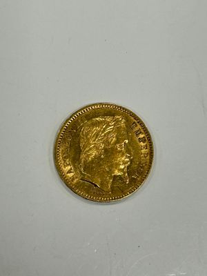 a close up of a gold coin on a white surface