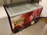 a large ice cream machine sitting in the corner of a kitchen