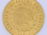 une image représentant une pièce d'or ornée d'une couronne sur l'avers