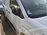 a white van parked in a parking lot with other cars