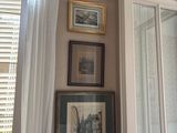 a bathroom with a shower and pictures on the wall