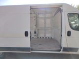a white van with its door open in a parking lot