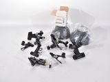 a bunch of black and white items sitting on top of a white surface