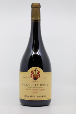 the bottle of wine is sitting on a white surface