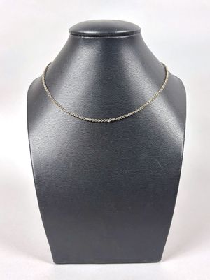a close up of a necklace on a mannequin with a white background