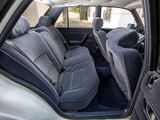 the back seats of a white car with black seats in it