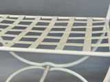 a white metal chair with a woven seat on it