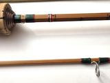 three different types of fishing rods are lined up on a table