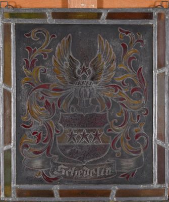 an old stained glass window with a coat of arms on it