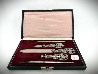 a silverware set in a case on a white surface