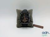 an image of a watch sitting on top of a pillow on a white surface