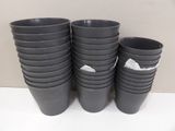 several black plastic cups are stacked on top of each other