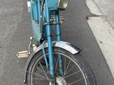 a blue motorcycle parked on the side of the road
