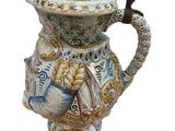 a ceramic pitcher with a lid and a handle