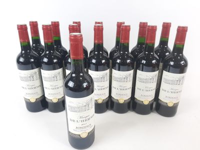 six bottles of red wine lined up in a row on a white surface