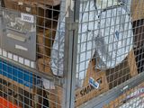 a metal cage with boxes on top of it in a warehouse