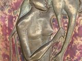 a bronze sculpture of a man holding a dog