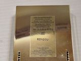 a gold box with a label on it sitting on a table