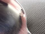 a close up of a person ' s hand holding a pair of sunglasses