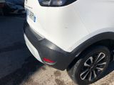 the rear end of a white car parked in a parking lot