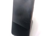 a broken cell phone sitting on a stand on a table