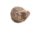 a close up of a small stone object on a white surface
