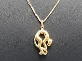 a gold plated necklace with a snake on a chain