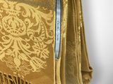 an image of a close up of a gold scarf on a mannequin