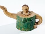 une figurine en céramique représentant un homme coiffé d'un chapeau