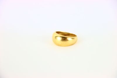 a close up of a gold ring on a white surface