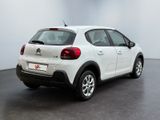 the back of a white citrole parked in a white room