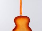 a close up of a guitar hanging from a string