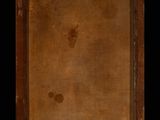 an old book with a brown cover sitting on top of a table