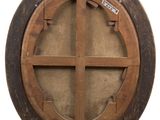 a round window with a wooden frame in the middle