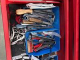 une boîte rouge contenant des outils sur le sol