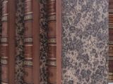 five books that are lined up on a shelf