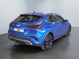 the rear end of a blue car in a showroom