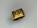 an image of a gold signet ring with the word i love you written on it