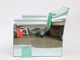 a mirror that is sitting on the floor in front of a chair