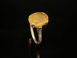 Gros plan sur une bague contenant une pierre jaune
